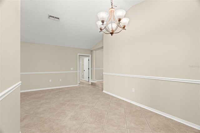 unfurnished room with a notable chandelier, visible vents, light tile patterned flooring, vaulted ceiling, and baseboards