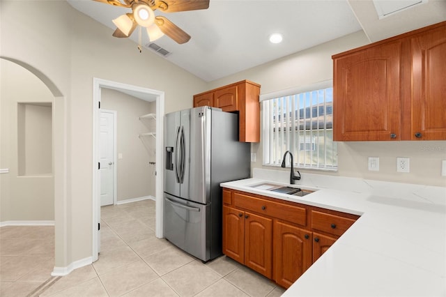 kitchen featuring visible vents, light countertops, a sink, and stainless steel fridge with ice dispenser