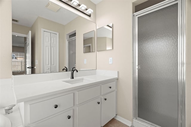 full bath with a stall shower, tile patterned floors, visible vents, and vanity