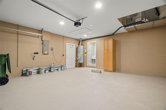 garage featuring water heater, electric panel, and a garage door opener