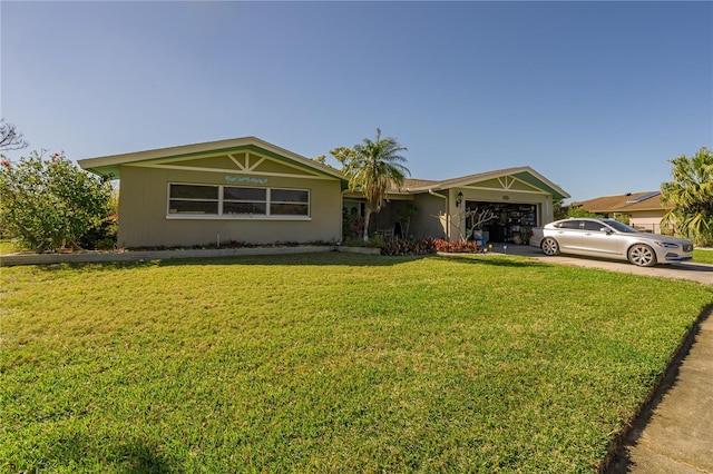 view of front facade with a front lawn, an attached garage, and driveway