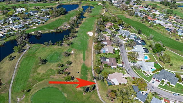 aerial view with golf course view, a water view, and a residential view