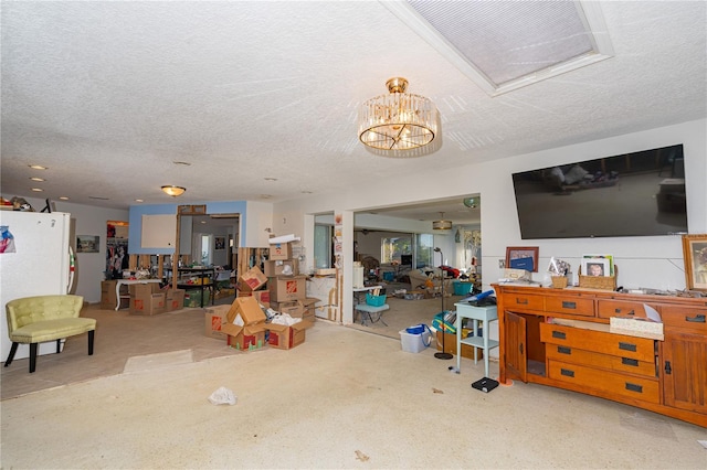 living room featuring a notable chandelier and a textured ceiling