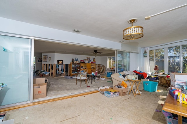 interior space featuring visible vents, concrete floors, and a ceiling fan