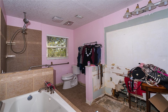 bathroom with visible vents, a textured ceiling, toilet, and a whirlpool tub