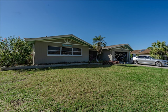 single story home with a front yard, concrete driveway, and an attached garage