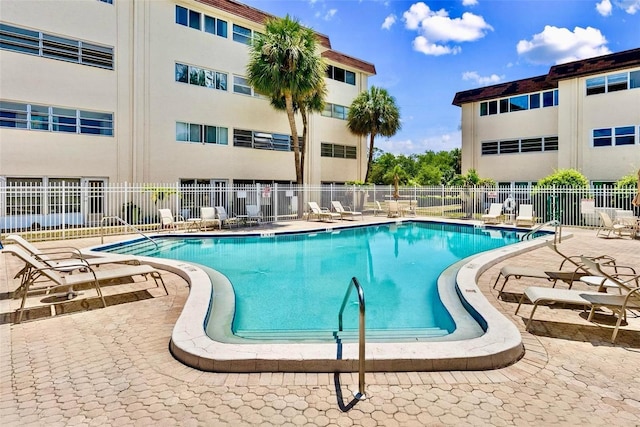 209 NE Lincoln Cir N Unit 105, Saint Petersburg, FL 33702 - community pool with fence and a patio