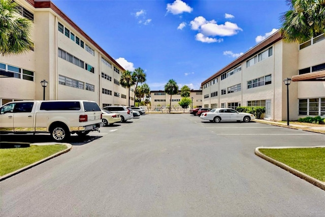 209 NE Lincoln Cir N Unit 105, Saint Petersburg, FL 33702 - view of asphalt street featuring street lights and curbs