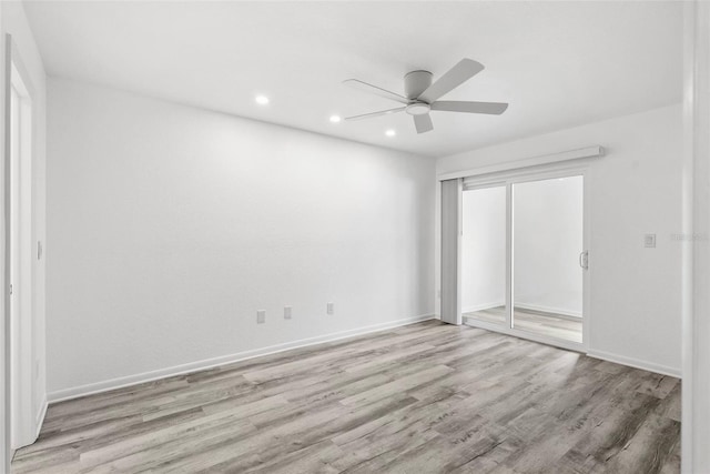 209 NE Lincoln Cir N Unit 105, Saint Petersburg, FL 33702 - unfurnished bedroom featuring wood finished floors, recessed lighting, a closet, baseboards, and ceiling fan