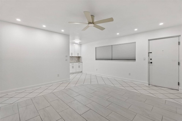 209 NE Lincoln Cir N Unit 105, Saint Petersburg, FL 33702 - unfurnished living room featuring ceiling fan, recessed lighting, and baseboards