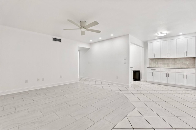 209 NE Lincoln Cir N Unit 105, Saint Petersburg, FL 33702 - unfurnished living room featuring a ceiling fan, baseboards, and recessed lighting