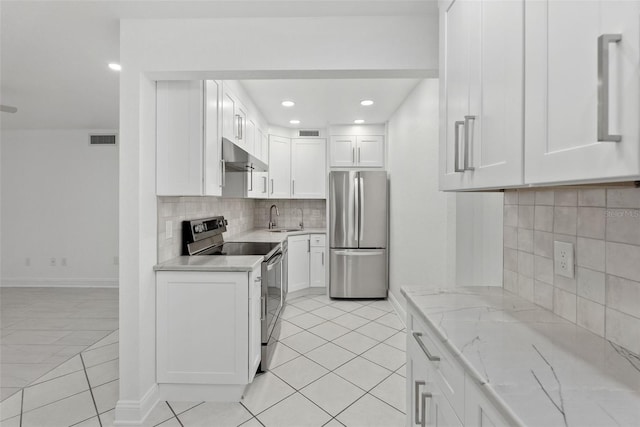 209 NE Lincoln Cir N Unit 105, Saint Petersburg, FL 33702 - kitchen featuring stainless steel appliances, under cabinet range hood, a sink, light tile patterned flooring, and recessed lighting