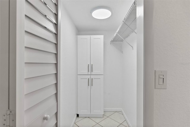 209 NE Lincoln Cir N Unit 105, Saint Petersburg, FL 33702 - walk in closet with light tile patterned floors
