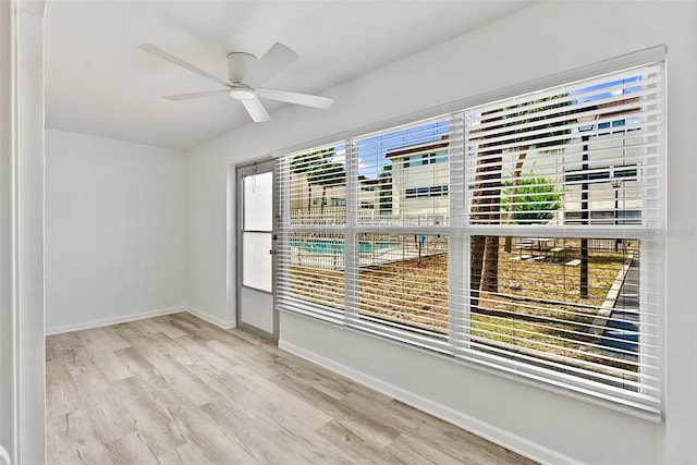 209 NE Lincoln Cir N Unit 105, Saint Petersburg, FL 33702 - spare room featuring wood finished floors, ceiling fan, and baseboards