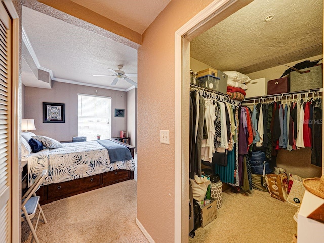 bedroom featuring a textured wall, ornamental molding, carpet, a textured ceiling, and a closet