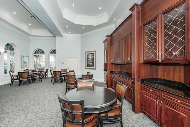 dining room featuring crown molding, baseboards, recessed lighting, light carpet, and a tray ceiling