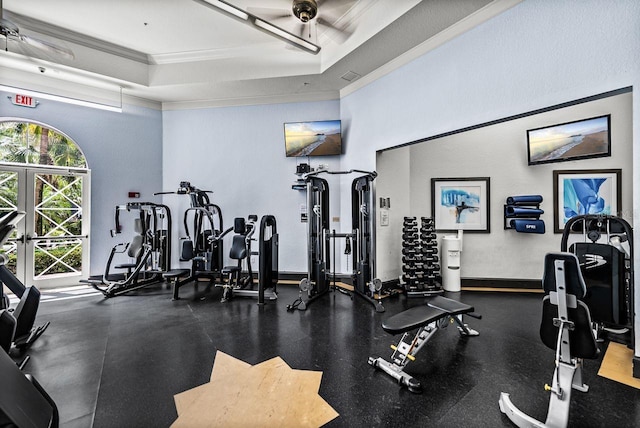 workout area featuring crown molding, ceiling fan, and a raised ceiling