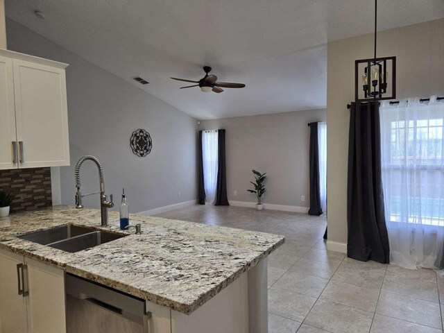 kitchen featuring a healthy amount of sunlight, dishwasher, decorative backsplash, and a sink