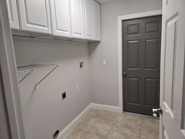 laundry area with hookup for a washing machine, cabinet space, light tile patterned flooring, electric dryer hookup, and baseboards