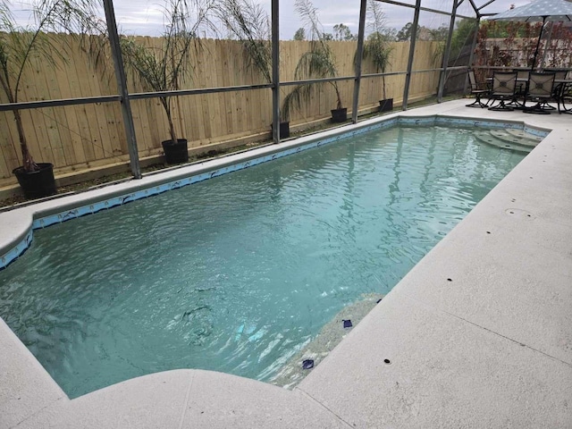 view of pool with a patio, a fenced backyard, a lanai, and a fenced in pool