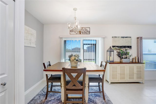 dining space featuring a chandelier, baseboards, and light tile patterned floors