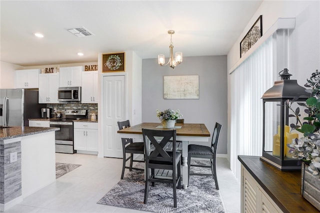 dining room featuring a chandelier, recessed lighting, visible vents, and light tile patterned floors