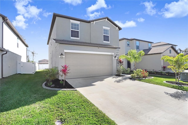 traditional home with stucco siding, concrete driveway, an attached garage, fence, and a front lawn