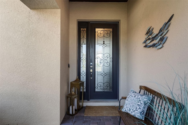 property entrance featuring stucco siding