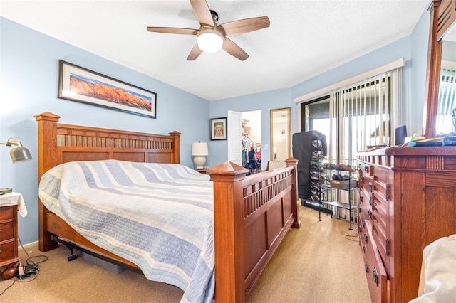 bedroom with a ceiling fan and light colored carpet