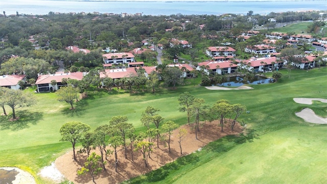 drone / aerial view featuring view of golf course and a water view