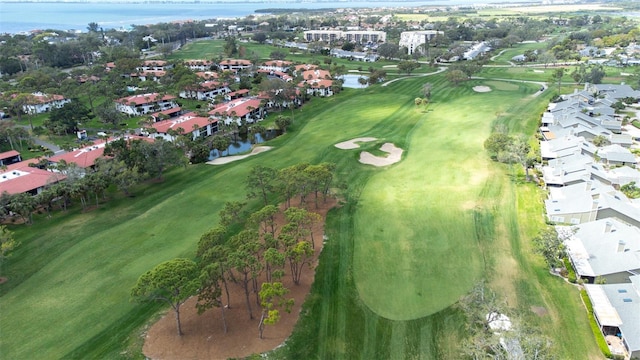 drone / aerial view with a water view, a residential view, and golf course view