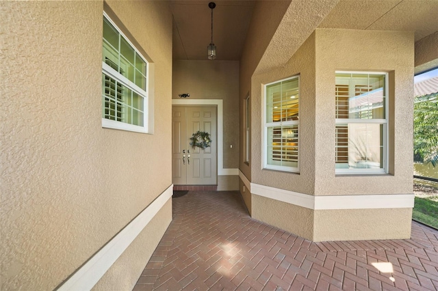 property entrance with stucco siding