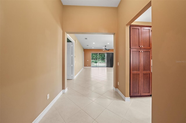 hall with light tile patterned floors and baseboards