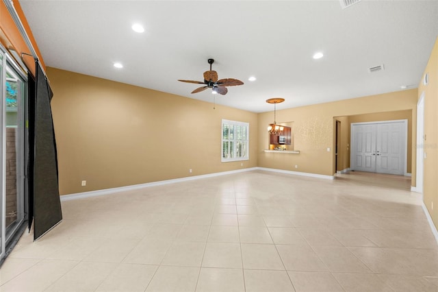 unfurnished living room featuring recessed lighting, ceiling fan with notable chandelier, baseboards, and visible vents