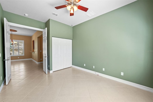 unfurnished bedroom featuring visible vents, baseboards, a closet, and light tile patterned flooring