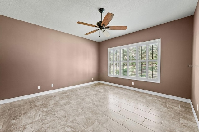 unfurnished room featuring baseboards, a textured ceiling, and a ceiling fan