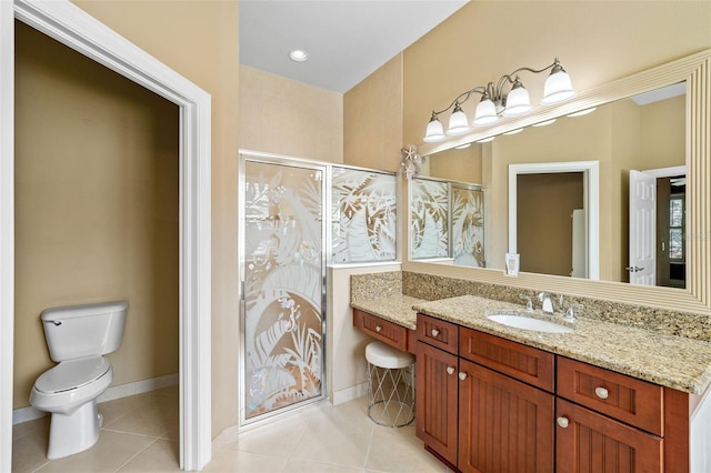 bathroom featuring tile patterned floors, toilet, a stall shower, and vanity