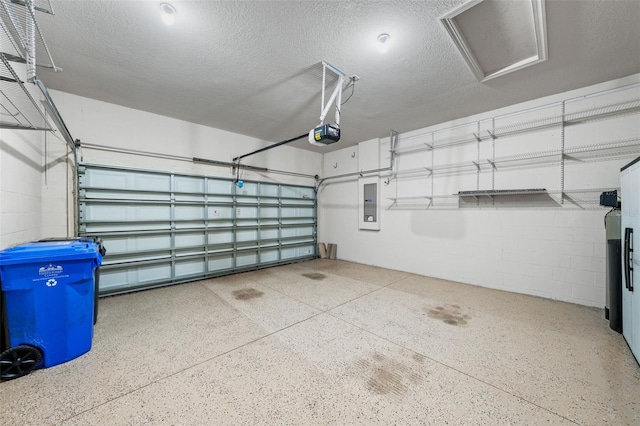 garage featuring electric panel, a garage door opener, and concrete block wall