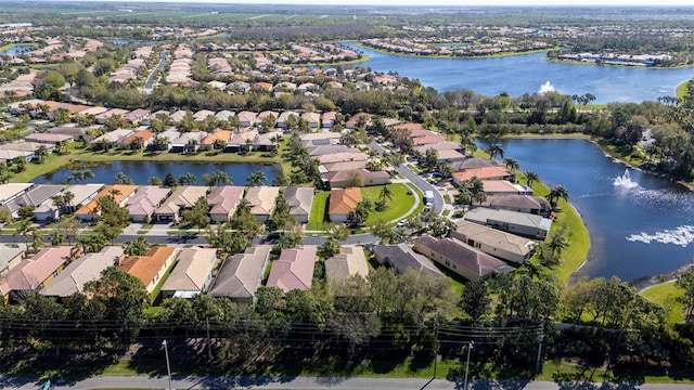 birds eye view of property with a residential view and a water view