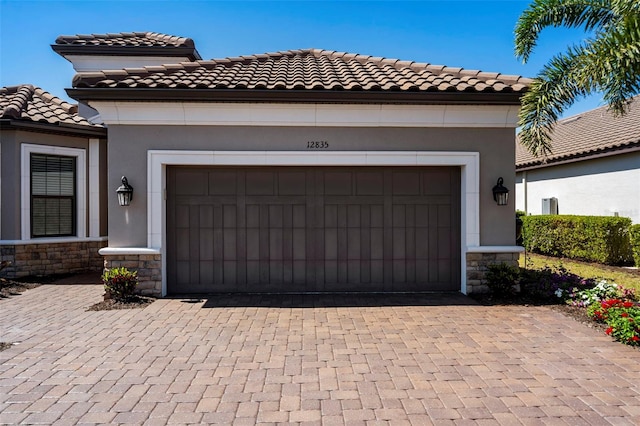 garage with decorative driveway