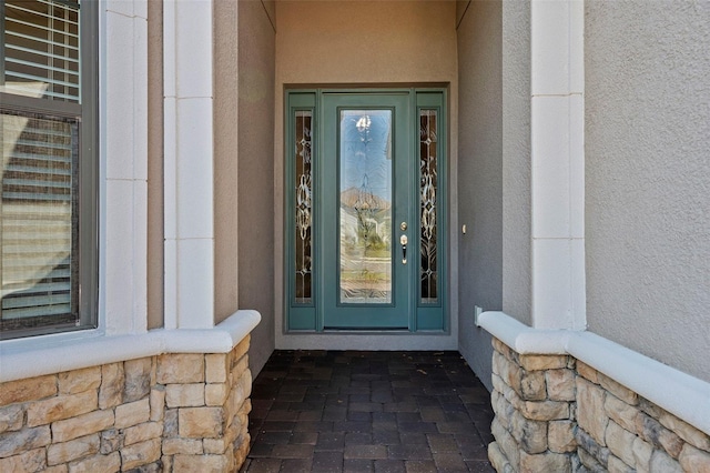 property entrance with stucco siding