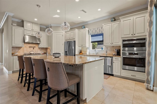 kitchen with visible vents, under cabinet range hood, ornamental molding, light tile patterned floors, and stainless steel appliances