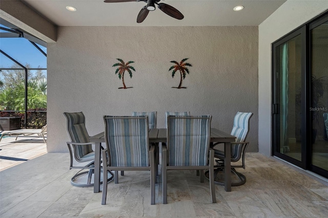 view of patio / terrace with a lanai, outdoor dining area, and ceiling fan