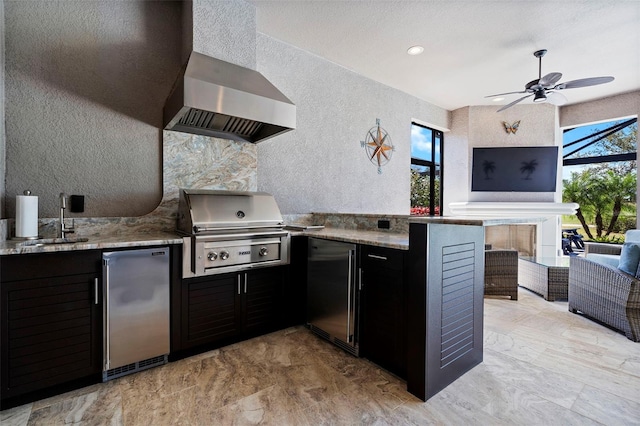 view of patio / terrace featuring grilling area, ceiling fan, a lanai, exterior kitchen, and a sink