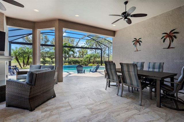 view of patio / terrace featuring a lanai, outdoor dining space, and ceiling fan