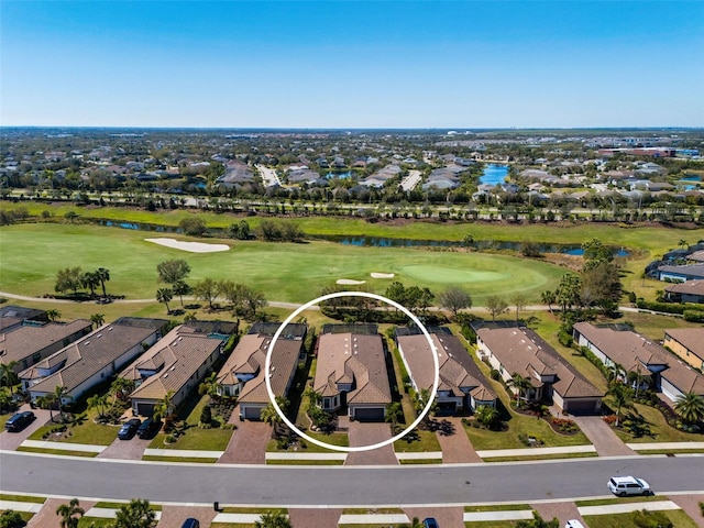 aerial view featuring a residential view, view of golf course, and a water view