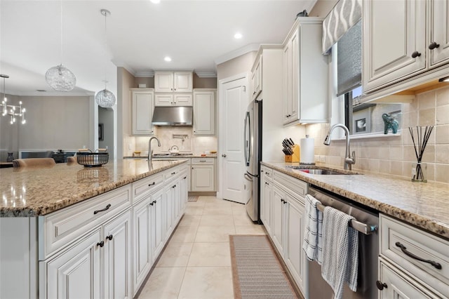 kitchen with light tile patterned floors, ornamental molding, stainless steel appliances, a sink, and under cabinet range hood