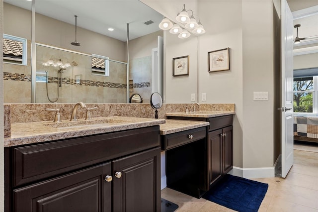 full bathroom with double vanity, baseboards, walk in shower, and a sink