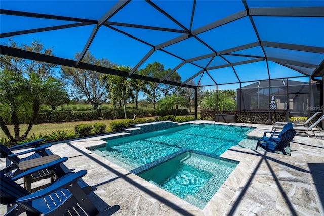 view of pool featuring glass enclosure, a patio, and a pool with connected hot tub