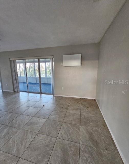 spare room featuring baseboards